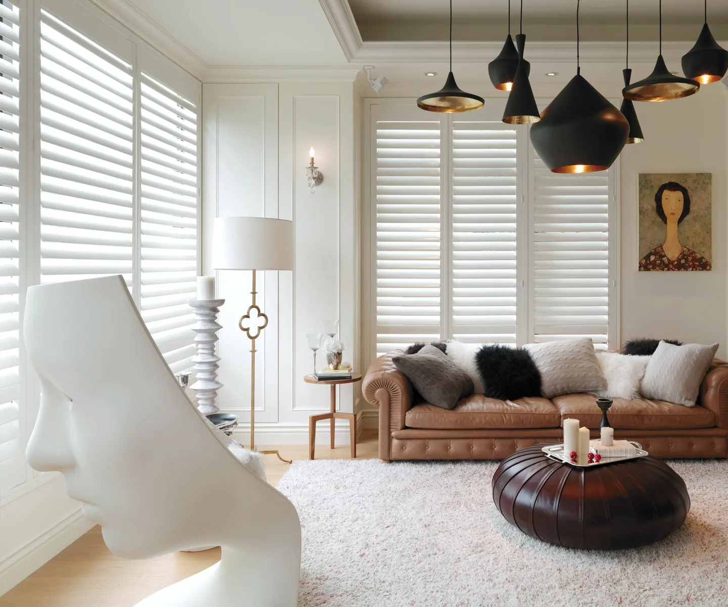 Artsy living area with hanging lights and clean, plantation shutters in Fairfax, Va