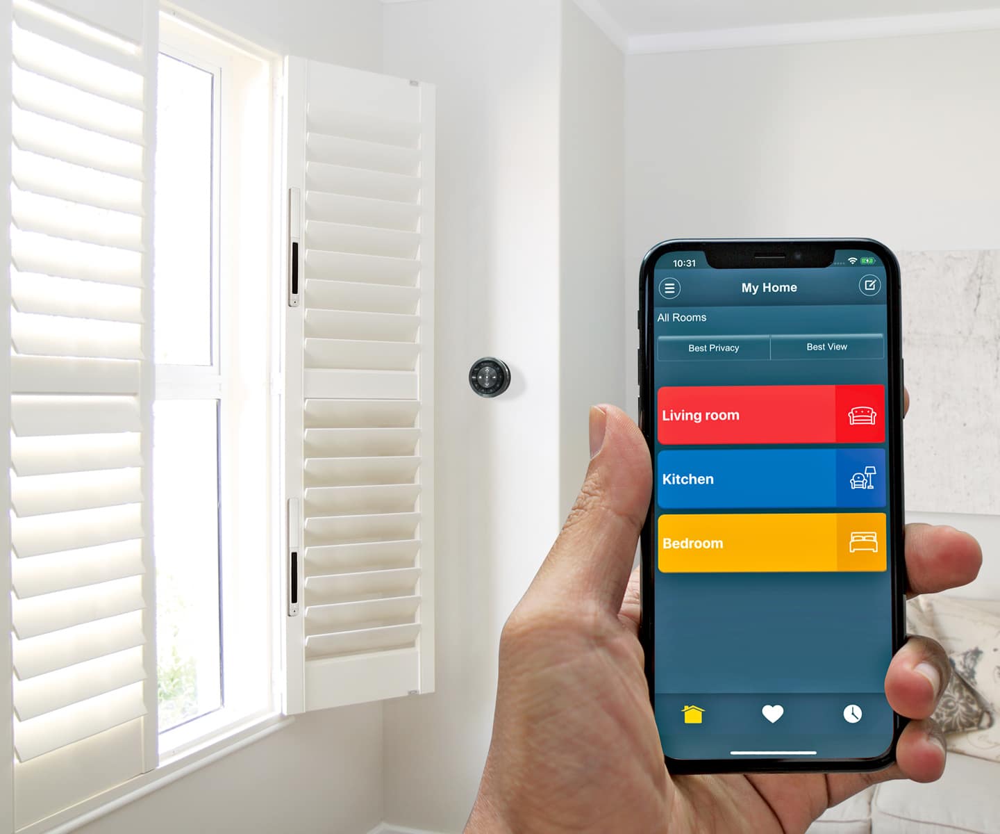 Near Falls Church, Va, someone holds their phone to control PerfectTilt G4 Motorized Shutters in a white room